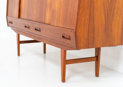 Teak highboard by P. Westergaard (Denmark, 1960s). This beautiful highboard comes with four sliding Doors and two wide drawers. It has beautiful teak wood patterns, nice inset handels and tons of storage space on the inside. Its in very good vintage condition with a few repair marks and small age related using traces. Labeled by maker.