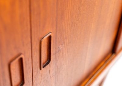Teak highboard by P. Westergaard (Denmark, 1960s). This beautiful highboard comes with four sliding Doors and two wide drawers. It has beautiful teak wood patterns, nice inset handels and tons of storage space on the inside. Its in very good vintage condition with a few repair marks and small age related using traces. Labeled by maker.