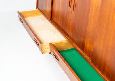 Teak highboard by P. Westergaard (Denmark, 1960s). This beautiful highboard comes with four sliding Doors and two wide drawers. It has beautiful teak wood patterns, nice inset handels and tons of storage space on the inside. Its in very good vintage condition with a few repair marks and small age related using traces. Labeled by maker.