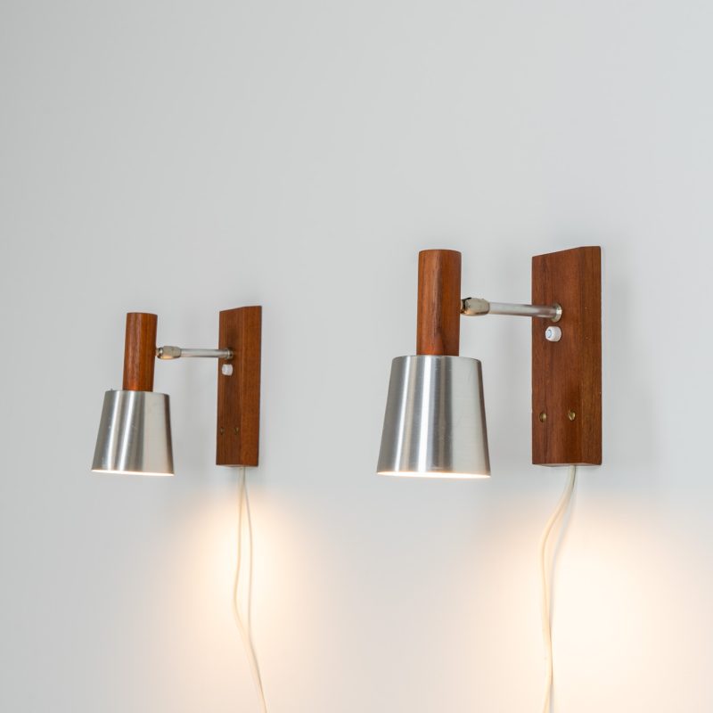 Stunning pair of Mid-century “Silva” wall lights by Lyfa (Denmark, 1960s). Each fixture features a solid teak base and cone, a sleek stainless steel adjustable arm, and a beautifully brushed aluminum lampshade. The combination of warm wood tones and cool metallic accents gives these lights a refined yet contemporary aesthetic. Both pieces are in very good condition, with only minor surface scratches on the shades. A true statement piece for any interior.