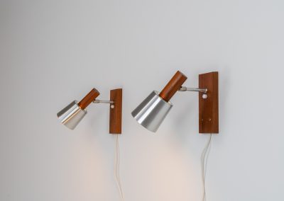 Stunning pair of Mid-century “Silva” wall lights by Lyfa (Denmark, 1960s). Each fixture features a solid teak base and cone, a sleek stainless steel adjustable arm, and a beautifully brushed aluminum lampshade. The combination of warm wood tones and cool metallic accents gives these lights a refined yet contemporary aesthetic. Both pieces are in very good condition, with only minor surface scratches on the shades. A true statement piece for any interior.