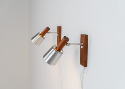 Stunning pair of Mid-century “Silva” wall lights by Lyfa (Denmark, 1960s). Each fixture features a solid teak base and cone, a sleek stainless steel adjustable arm, and a beautifully brushed aluminum lampshade. The combination of warm wood tones and cool metallic accents gives these lights a refined yet contemporary aesthetic. Both pieces are in very good condition, with only minor surface scratches on the shades. A true statement piece for any interior.