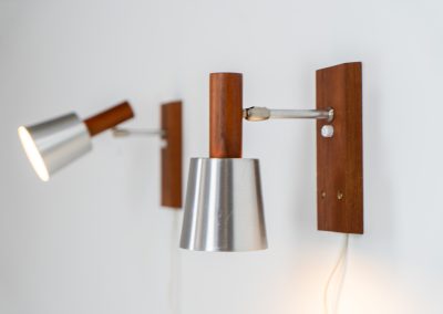 Stunning pair of Mid-century “Silva” wall lights by Lyfa (Denmark, 1960s). Each fixture features a solid teak base and cone, a sleek stainless steel adjustable arm, and a beautifully brushed aluminum lampshade. The combination of warm wood tones and cool metallic accents gives these lights a refined yet contemporary aesthetic. Both pieces are in very good condition, with only minor surface scratches on the shades. A true statement piece for any interior.