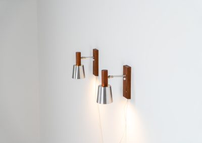 Stunning pair of Mid-century “Silva” wall lights by Lyfa (Denmark, 1960s). Each fixture features a solid teak base and cone, a sleek stainless steel adjustable arm, and a beautifully brushed aluminum lampshade. The combination of warm wood tones and cool metallic accents gives these lights a refined yet contemporary aesthetic. Both pieces are in very good condition, with only minor surface scratches on the shades. A true statement piece for any interior.