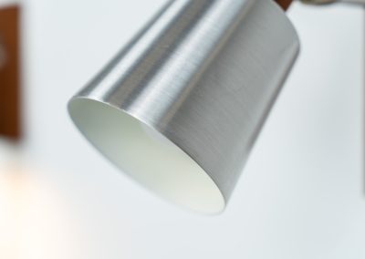 Stunning pair of Mid-century “Silva” wall lights by Lyfa (Denmark, 1960s). Each fixture features a solid teak base and cone, a sleek stainless steel adjustable arm, and a beautifully brushed aluminum lampshade. The combination of warm wood tones and cool metallic accents gives these lights a refined yet contemporary aesthetic. Both pieces are in very good condition, with only minor surface scratches on the shades. A true statement piece for any interior.