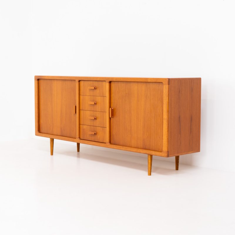 Wonderful teak sideboard with tambour doors by CFC Silkeborg (Denmark, 1960s). The sideboard is made out of teak and features stunning organic shapes and lots of amazing details, like the two tambour doors and the rounded handles. The shelves on the inside are adjustable and the four big drawers offer lots of storage space. The backside is nicely finished so I can be used freedtanding aswell. This piece presents itself in mint condition with no damages or significant using traces.