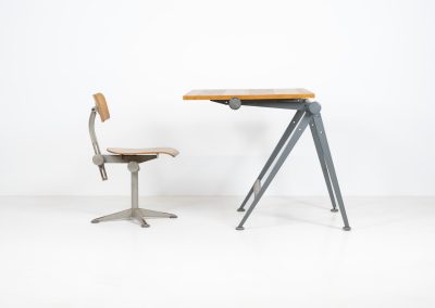“Reply” drafting table and chair by Wim Rietveld & Friso Kramer for Ahrend de Cirkel (The Netherlands, 1950s). This highly adjustable collaboration by Friso Kramer & Wim Rietveld makes it possible to use the table at any preferred height and position. It won the prestigious ‘Singe d’Or’ in Brussels 1963. It consists of an enameled metal frame and a wooden top which both have a nice patina and age related using traces. A perfect piece to use as a writing desk or architect table. The table and chair are both marked by maker.