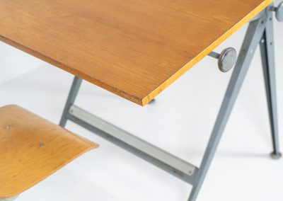 “Reply” drafting table and chair by Wim Rietveld & Friso Kramer for Ahrend de Cirkel (The Netherlands, 1950s). This highly adjustable collaboration by Friso Kramer & Wim Rietveld makes it possible to use the table at any preferred height and position. It won the prestigious ‘Singe d’Or’ in Brussels 1963. It consists of an enameled metal frame and a wooden top which both have a nice patina and age related using traces. A perfect piece to use as a writing desk or architect table. The table and chair are both marked by maker.