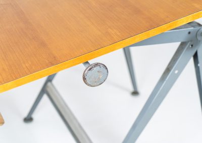 “Reply” drafting table and chair by Wim Rietveld & Friso Kramer for Ahrend de Cirkel (The Netherlands, 1950s). This highly adjustable collaboration by Friso Kramer & Wim Rietveld makes it possible to use the table at any preferred height and position. It won the prestigious ‘Singe d’Or’ in Brussels 1963. It consists of an enameled metal frame and a wooden top which both have a nice patina and age related using traces. A perfect piece to use as a writing desk or architect table. The table and chair are both marked by maker.