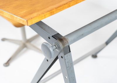 “Reply” drafting table and chair by Wim Rietveld & Friso Kramer for Ahrend de Cirkel (The Netherlands, 1950s). This highly adjustable collaboration by Friso Kramer & Wim Rietveld makes it possible to use the table at any preferred height and position. It won the prestigious ‘Singe d’Or’ in Brussels 1963. It consists of an enameled metal frame and a wooden top which both have a nice patina and age related using traces. A perfect piece to use as a writing desk or architect table. The table and chair are both marked by maker.