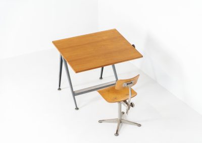 “Reply” drafting table and chair by Wim Rietveld & Friso Kramer for Ahrend de Cirkel (The Netherlands, 1950s). This highly adjustable collaboration by Friso Kramer & Wim Rietveld makes it possible to use the table at any preferred height and position. It won the prestigious ‘Singe d’Or’ in Brussels 1963. It consists of an enameled metal frame and a wooden top which both have a nice patina and age related using traces. A perfect piece to use as a writing desk or architect table. The table and chair are both marked by maker.