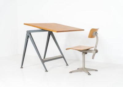 “Reply” drafting table and chair by Wim Rietveld & Friso Kramer for Ahrend de Cirkel (The Netherlands, 1950s). This highly adjustable collaboration by Friso Kramer & Wim Rietveld makes it possible to use the table at any preferred height and position. It won the prestigious ‘Singe d’Or’ in Brussels 1963. It consists of an enameled metal frame and a wooden top which both have a nice patina and age related using traces. A perfect piece to use as a writing desk or architect table. The table and chair are both marked by maker.