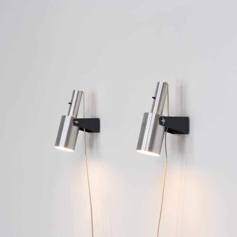 Beautiful pair of “Sonet” wall lights by Hans P. Jeppesen for Fog & Mørup (Denmark, 1960s). These modernist fixtures feature a black lacquered metal base and a brushed aluminium lamp shade, they are easily adjustable in multiple angles and directions. Both pieces are in original condition. They do have a few dents and surface scratches, but are in very good vintage condition! Labeled by maker.