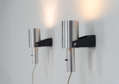 Beautiful pair of “Sonet” wall lights by Hans P. Jeppesen for Fog & Mørup (Denmark, 1960s). These modernist fixtures feature a black lacquered metal base and a brushed aluminium lamp shade, they are easily adjustable in multiple angles and directions. Both pieces are in original condition. They do have a few dents and surface scratches, but are in very good vintage condition! Labeled by maker.