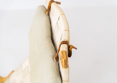 “Miranda” easy chair by Bruno Mathsson Design Studio (Sweden, 1970s). Originally designed by Bruno Mathsson in 1941, this exceptional “Miranda” easy chair was manufactured in the 1970s. It features a beautifully curved, molded beech plywood frame with a linen webbing seat and an adjustable headrest, suspended by leather straps. The chair is in good vintage condition, showing signs of use such as marks, fabric fraying, and some damage to the wood, all of which add to its authentic character. Marked by maker.