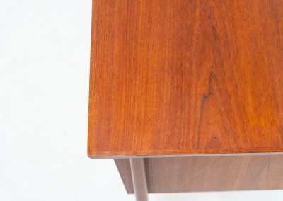 Freestanding desk by Gunnar Nielsen Tibergaard (Denmark, 1960s). A beautifully designed and elegant teak desk from the 1960s, featuring four drawers and a finished back that allows it to stand freely in any space. The rear side includes an open storage area/bookcase and a cabinet with a drop-down leaf. The desk is in very good condition with one very small chip in the wood on the right back-corner as shown on the pictures.