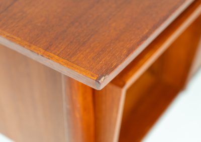 Freestanding desk by Gunnar Nielsen Tibergaard (Denmark, 1960s). A beautifully designed and elegant teak desk from the 1960s, featuring four drawers and a finished back that allows it to stand freely in any space. The rear side includes an open storage area/bookcase and a cabinet with a drop-down leaf. The desk is in very good condition with one very small chip in the wood on the right back-corner as shown on the pictures.