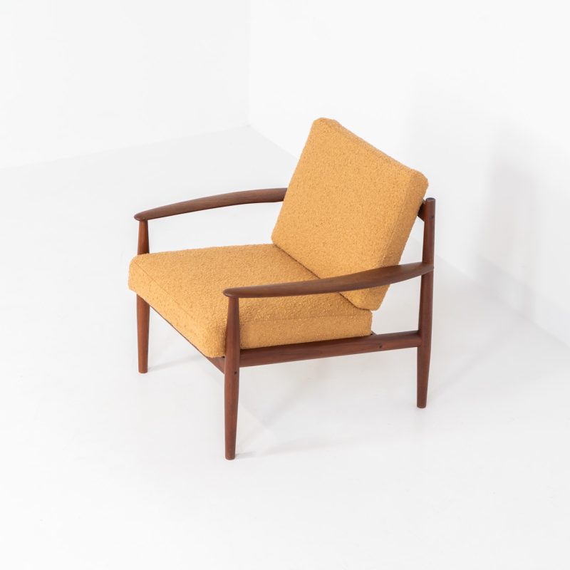 “FD-128” easy chair by Grete Jalk for France & Son (Denmark, 1960s). This elegant masterpiece is a fine example of Scandinavian modernism. It features a solid teak frame with a warm natural grain, stunning curves and comfortable cushions, newly upholstered in a earthy orange/brown bouclé fabric. The chair presents itself in very good condition and labeled.