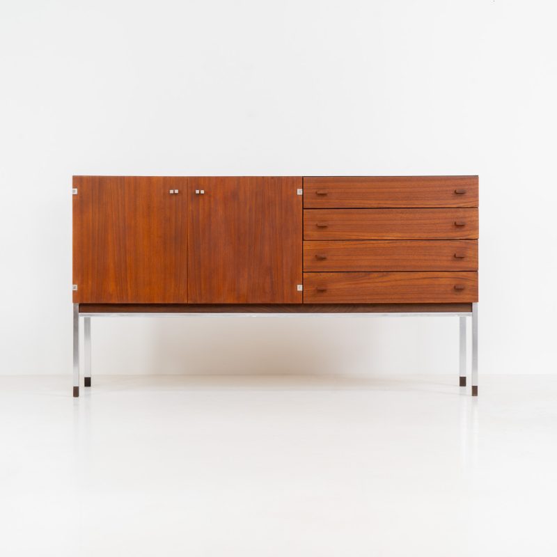 Modernist sideboard in teak (Belgium, 1950s). A beautiful compact sideboard crafted out of teak, featuring two doors and four drawers. It has a warm woodgrain, a sleek metal frame and sculptural teak handles. In good condition with visible using traces and some repair marks.