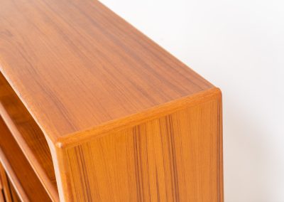 Beautiful bookcase in teak by Svend Dyrlund with tambour doors (Denmark, 1960s). This bookcase perfectly combines organic shapes and loads of detail, like the tambour sliding doors, the beautiful handles or the bulky shelves, which are adjustable in height. It offers lots of storage space! In mint condition!