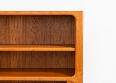 Beautiful bookcase in teak by Svend Dyrlund with tambour doors (Denmark, 1960s). This bookcase perfectly combines organic shapes and loads of detail, like the tambour sliding doors, the beautiful handles or the bulky shelves, which are adjustable in height. It offers lots of storage space! In mint condition!