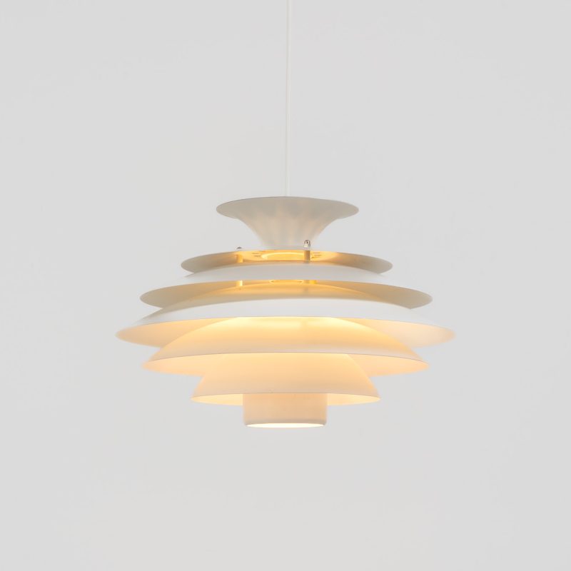 Pendant light by Jeka Metaltryk (Denmark, 1970s). A striking pendant light featuring a dynamic, sculptural form crafted from seven layered steel shades. The design softly diffuses light, creating a warm and calming glow. The lamp has been newly rewired and is in excellent condition.