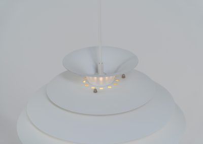 Pendant light by Jeka Metaltryk (Denmark, 1970s). A striking pendant light featuring a dynamic, sculptural form crafted from seven layered steel shades. The design softly diffuses light, creating a warm and calming glow. The lamp has been newly rewired and is in excellent condition.