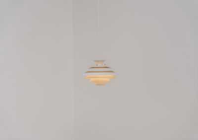 Pendant light by Jeka Metaltryk (Denmark, 1970s). A striking pendant light featuring a dynamic, sculptural form crafted from seven layered steel shades. The design softly diffuses light, creating a warm and calming glow. The lamp has been newly rewired and is in excellent condition.