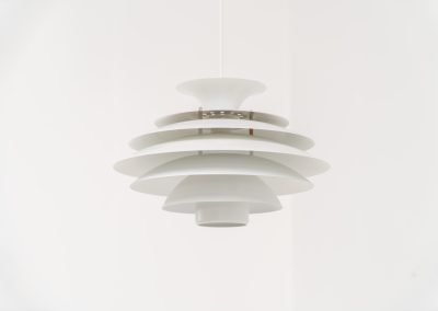 Pendant light by Jeka Metaltryk (Denmark, 1970s). A striking pendant light featuring a dynamic, sculptural form crafted from seven layered steel shades. The design softly diffuses light, creating a warm and calming glow. The lamp has been newly rewired and is in excellent condition.