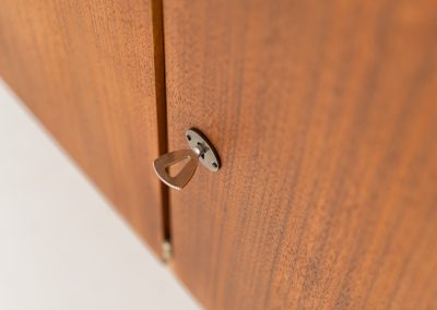 XL Modernist sideboard by Behr Möbel (Germany, 1950s). This striking modernist sideboard was produced in the 1950s by the renowned German manufacturer Behr Möbel, best known for the iconic B40 model. Expertly crafted from rich teak wood, the piece rests on a sleek metal base that adds to its architectural presence. It features four drawers and three doors, offering generous storage space with adjustable shelves inside. The sideboard is in very good condition, with fully functional locks.