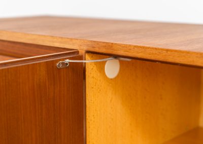 XL Modernist sideboard by Behr Möbel (Germany, 1950s). This striking modernist sideboard was produced in the 1950s by the renowned German manufacturer Behr Möbel, best known for the iconic B40 model. Expertly crafted from rich teak wood, the piece rests on a sleek metal base that adds to its architectural presence. It features four drawers and three doors, offering generous storage space with adjustable shelves inside. The sideboard is in very good condition, with fully functional locks.