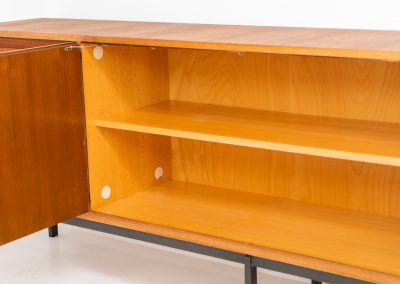 XL Modernist sideboard by Behr Möbel (Germany, 1950s). This striking modernist sideboard was produced in the 1950s by the renowned German manufacturer Behr Möbel, best known for the iconic B40 model. Expertly crafted from rich teak wood, the piece rests on a sleek metal base that adds to its architectural presence. It features four drawers and three doors, offering generous storage space with adjustable shelves inside. The sideboard is in very good condition, with fully functional locks.