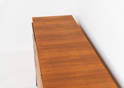 XL Modernist sideboard by Behr Möbel (Germany, 1950s). This striking modernist sideboard was produced in the 1950s by the renowned German manufacturer Behr Möbel, best known for the iconic B40 model. Expertly crafted from rich teak wood, the piece rests on a sleek metal base that adds to its architectural presence. It features four drawers and three doors, offering generous storage space with adjustable shelves inside. The sideboard is in very good condition, with fully functional locks.