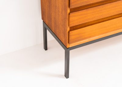 XL Modernist sideboard by Behr Möbel (Germany, 1950s). This striking modernist sideboard was produced in the 1950s by the renowned German manufacturer Behr Möbel, best known for the iconic B40 model. Expertly crafted from rich teak wood, the piece rests on a sleek metal base that adds to its architectural presence. It features four drawers and three doors, offering generous storage space with adjustable shelves inside. The sideboard is in very good condition, with fully functional locks.