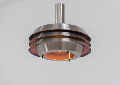 Beautiful pendant light by Lyskaer Belysning (Denmark, 1970s). An amazing design crafted out of four brushed aluminium shades. The inside is lacquered in purple which gives a beautiful effect when the light is turned on, and a colorful touch when it is turned off. The lamp is in very good condition and newly rewired.