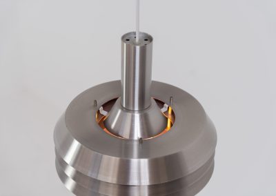 Beautiful pendant light by Lyskaer Belysning (Denmark, 1970s). An amazing design crafted out of four brushed aluminium shades. The inside is lacquered in purple which gives a beautiful effect when the light is turned on, and a colorful touch when it is turned off. The lamp is in very good condition and newly rewired.