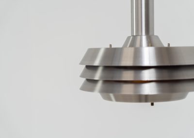 Beautiful pendant light by Lyskaer Belysning (Denmark, 1970s). An amazing design crafted out of four brushed aluminium shades. The inside is lacquered in purple which gives a beautiful effect when the light is turned on, and a colorful touch when it is turned off. The lamp is in very good condition and newly rewired.