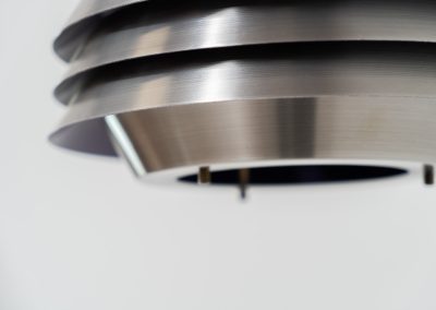 Beautiful pendant light by Lyskaer Belysning (Denmark, 1970s). An amazing design crafted out of four brushed aluminium shades. The inside is lacquered in purple which gives a beautiful effect when the light is turned on, and a colorful touch when it is turned off. The lamp is in very good condition and newly rewired.