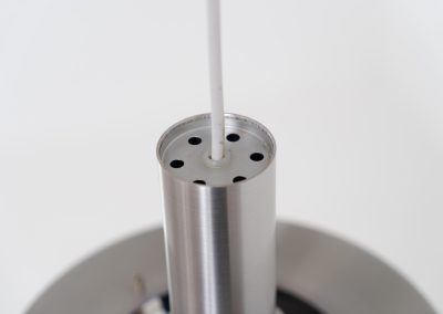 Beautiful pendant light by Lyskaer Belysning (Denmark, 1970s). An amazing design crafted out of four brushed aluminium shades. The inside is lacquered in purple which gives a beautiful effect when the light is turned on, and a colorful touch when it is turned off. The lamp is in very good condition and newly rewired.