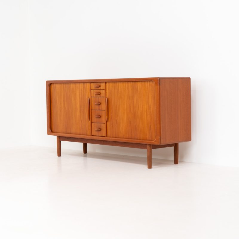 Exceptional sideboard with tambour doors by Svend Dyrlund (Denmark, 1960s). This exceptionally rare and gorgeous sideboard, designed by Svend Dyrlund is truly a work of art. It’s crafted out of teak and features stunning organic shapes and lots of amazing details, like the two tambour doors, the sculptural handles and the curved drawers on the inside. The shelve on the inside is adjustable. This piece presents itself in amazing condition with no damages or significant using traces. It is labeled aswell.