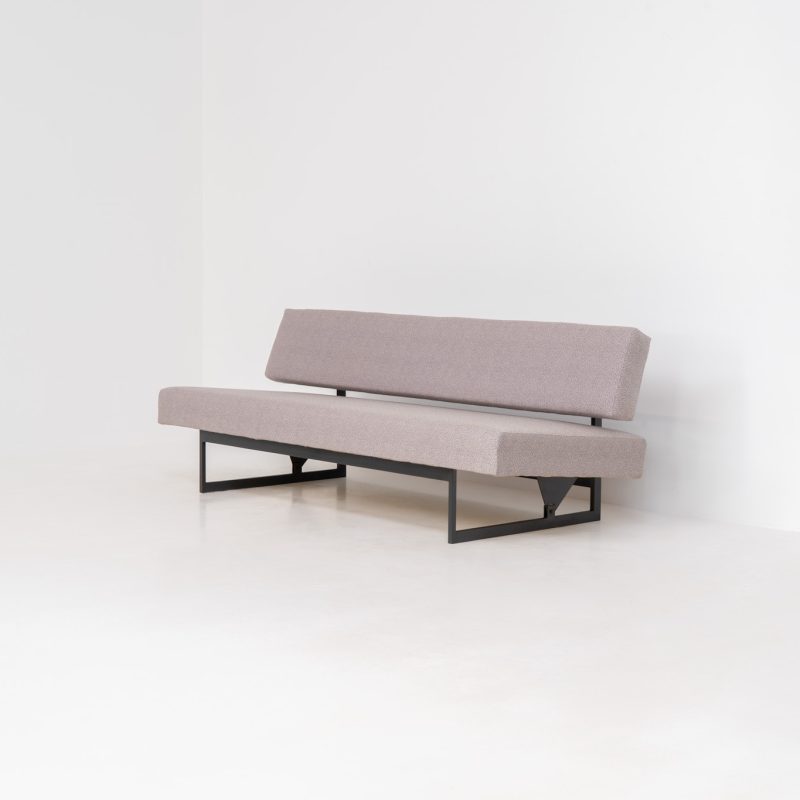 Sofa / daybed by Dieter Waeckerlin for Idealheim (Germany, 1950s). A wonderful and rare modernist piece designed by Swiss architect Dieter Waeckerlin. It features a black steel frame and comfortable cushions in a subtly patterned grey upholstery. Thanks to its tilting pendulum mechanism, the sofa can convert into a daybed. In very good vintage condition, with some light signs of use to the fabric.