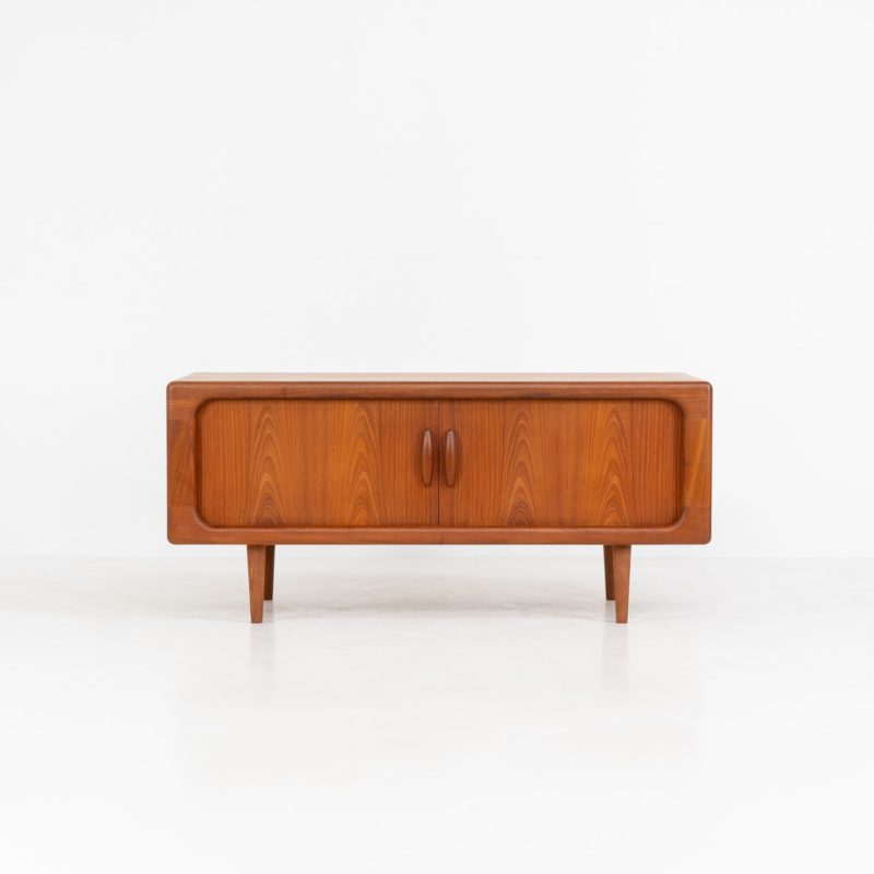 Beautiful lowboard with tambour doors by Svend Dyrlund (Denmark, 1960s). This elegant Danish piece, crafted in teak, features nice organic edges, refined tambour doors, and beautiful solid handles. The back has a factory hole that can be screwed open for cable management, making it a perfect piece for a television or audio gear! This piece is in splendid condition!