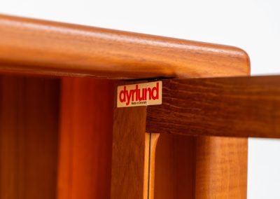 Stunning showcase by Svend Dyrlund (Denmark, 1960s). This exceptional piece features elegant doors with glass panels and beautifully crafted wooden handles, two adjustable shelves, and convenient backlights behind each shelf to highlight your displayed items. Made from rich teak with a natural woodgrain, it perfectly combines functionality with the timeless characteristic of Danish modern design. In splendid condition & labeled by maker.