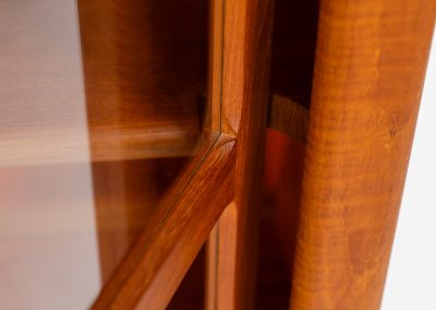 Stunning showcase by Svend Dyrlund (Denmark, 1960s). This exceptional piece features elegant doors with glass panels and beautifully crafted wooden handles, two adjustable shelves, and convenient backlights behind each shelf to highlight your displayed items. Made from rich teak with a natural woodgrain, it perfectly combines functionality with the timeless characteristic of Danish modern design. In splendid condition & labeled by maker.