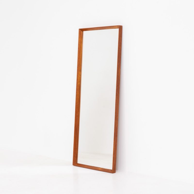 Danish Mid-Century wall mirror (Denmark, 1960s). A simple but beautiful wall mirror with a chamfered edge, made out of solid teak and brass connection joints. In good condition.