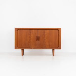 Svend Dyrlund teak sideboard with tambour doors (Denmark, 1960s). A fabulous sideboard that perfectly combines nice organic shapes and loads of detail, like the tambour sliding doors and the beautiful handles. It offers lots of storage space an adjustable shelve on the inside. In splendid condition! Labeled by maker.