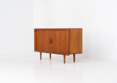 Svend Dyrlund teak sideboard with tambour doors (Denmark, 1960s). A fabulous sideboard that perfectly combines nice organic shapes and loads of detail, like the tambour sliding doors and the beautiful handles. It offers lots of storage space an adjustable shelve on the inside. In splendid condition! Labeled by maker.