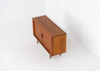 Svend Dyrlund teak sideboard with tambour doors (Denmark, 1960s). A fabulous sideboard that perfectly combines nice organic shapes and loads of detail, like the tambour sliding doors and the beautiful handles. It offers lots of storage space an adjustable shelve on the inside. In splendid condition! Labeled by maker.