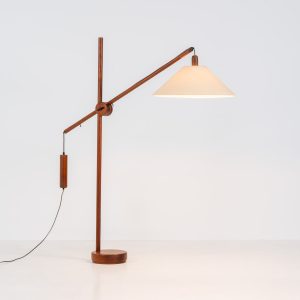 Exceptional Counter Balance floor lamp by Domus (Germany, 1970s). This striking piece features a sculptural solid teak stem and base, paired with a wild-silk lampshade. The lamp is highly adjustable in height and angle, making it suitable for both a compact reading lamp or an overhead ambient floor lamp. The lamp remains in its original, very good condition, a true statement piece for any interior.