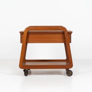 Teak serving trolley by Sika Møbler (Denmark, 1960s). An elegant and versatile piece crafted from warm teak. It features clean lines, dovetail joinery, and a functional two-tier design with a convenient drawer for storage. The trolley is mounted on smooth-rolling casters, making it both stylish and practical for serving or displaying items. The trolley remains in mint condition.